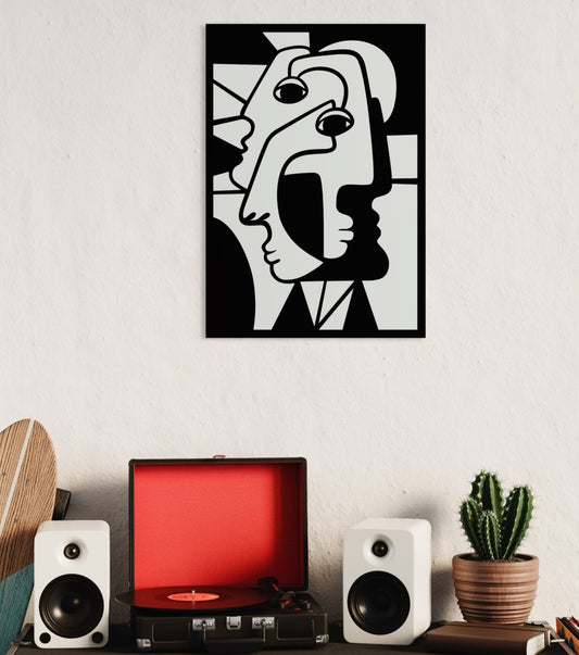 Cubist faces wooden wall decoration hanging on a white wall